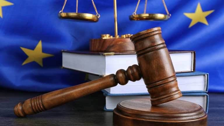 Judge gavel and books with scales on European Union flag background