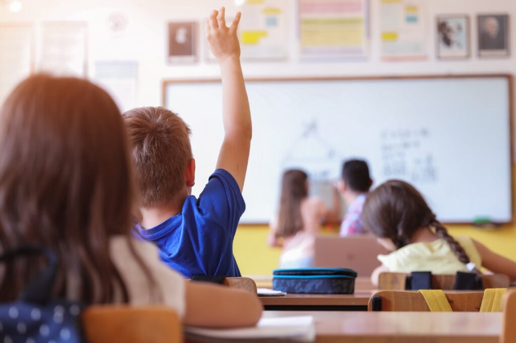 Kid raising hand in class