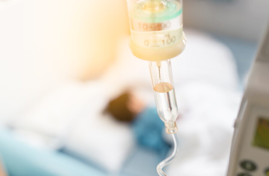 Sick child sleep on the bed in hospital during have a saline drip